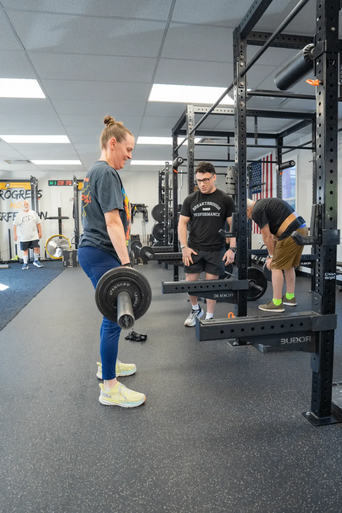 Coach guiding members through a personal training session at Breakthrough Performance