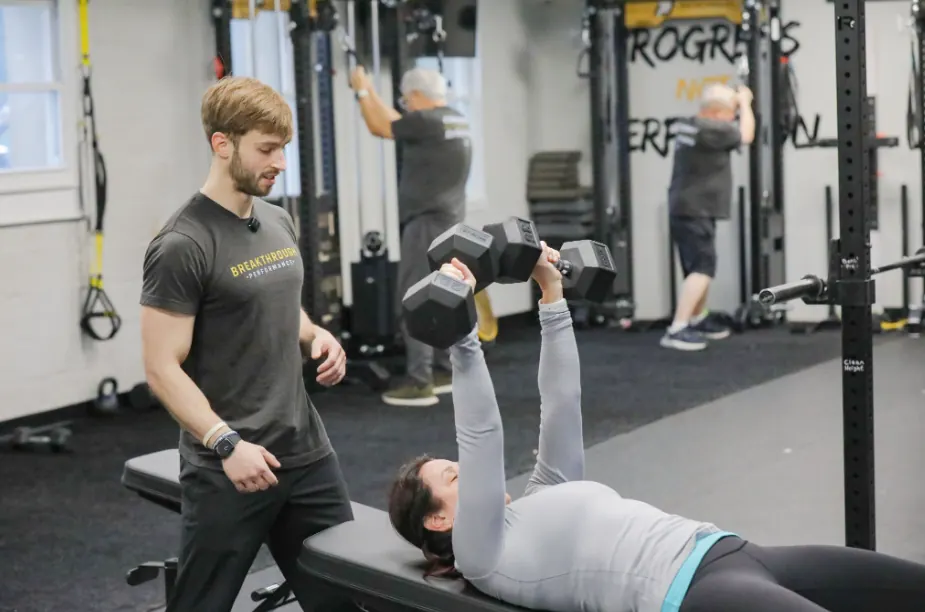 Coach supervising members during a strength session at Breakthrough Performance